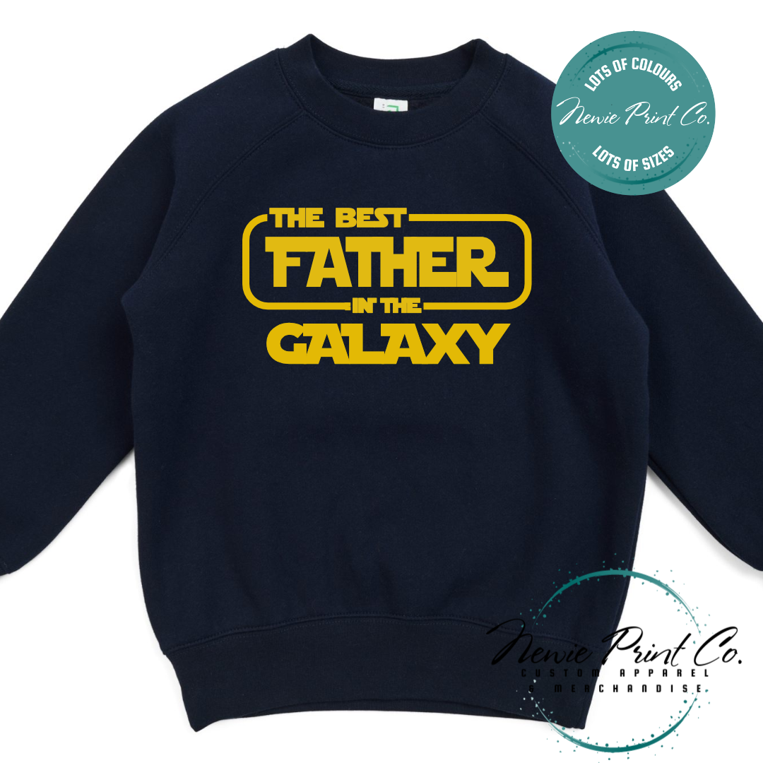 Funny t-shirt and jumper with the text “Best Father in the Galaxy customizable Humorous Star Wars-inspired quote printed on 100% cotton apparel using high-quality DTF/DTG print. Perfect gift for dads, Father’s Day.