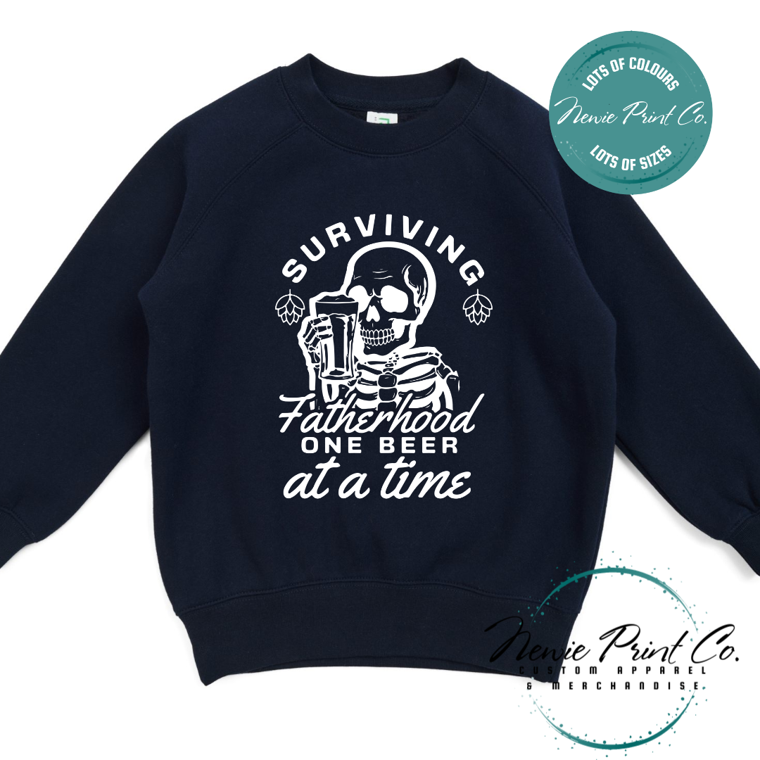 Funny t-shirt and jumper with the phrase “Surviving Fatherhood One Beer at a Time” featuring a skeleton holding a beer. Printed on soft cotton with high-quality DTF/DTG printing. Perfect humorous gift for dads, beer lovers, and Father's Day.