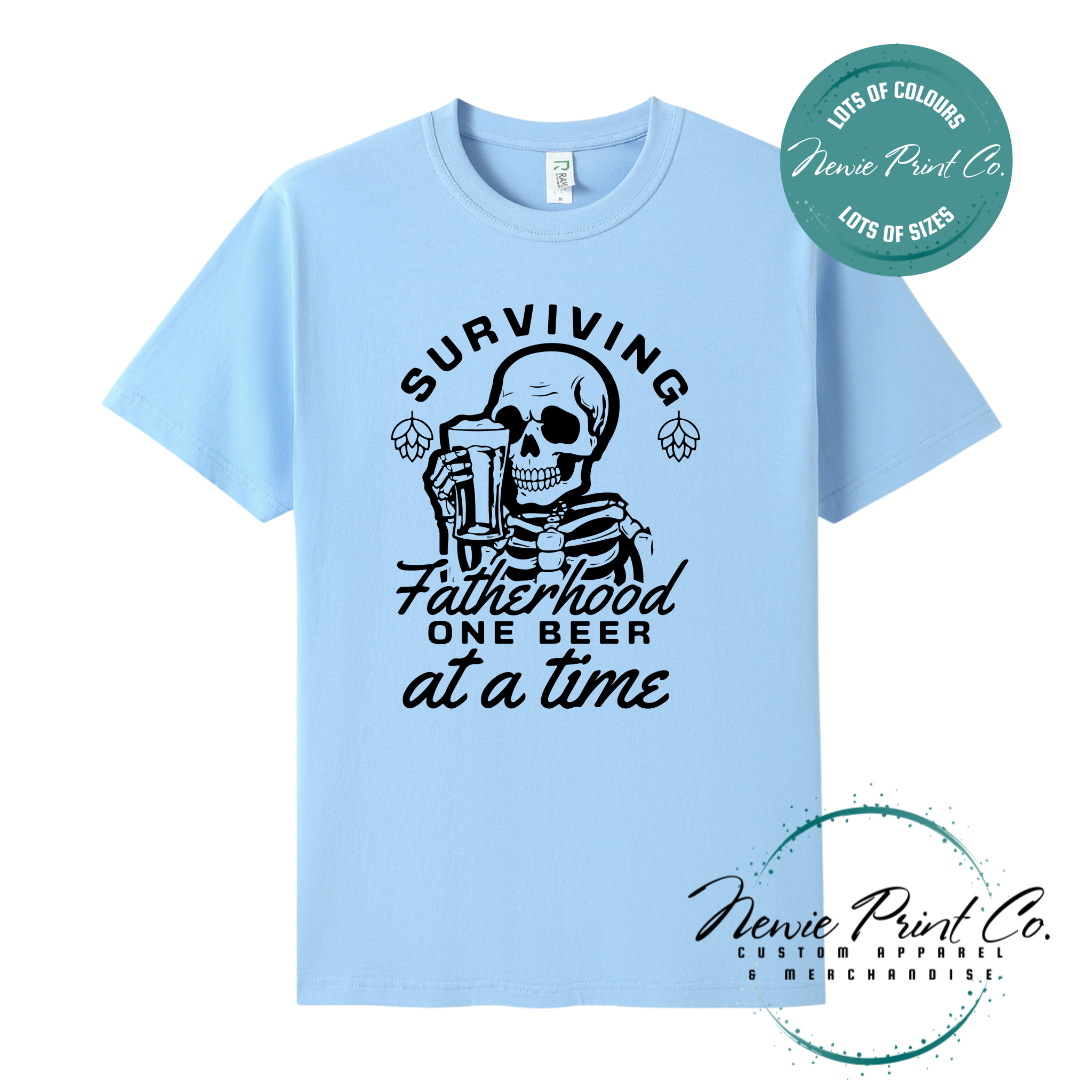 Funny t-shirt and jumper with the phrase “Surviving Fatherhood One Beer at a Time” featuring a skeleton holding a beer. Printed on soft cotton with high-quality DTF/DTG printing. Perfect humorous gift for dads, beer lovers, and Father's Day.