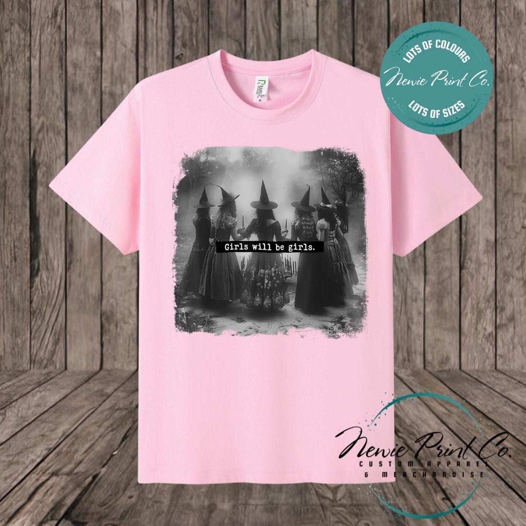 Witches in the forest design on custom t-shirt with the slogan “Girls Will Be Girls”. Feminist and empowering print on 100% cotton tee, perfect for girls and women, printed using high-quality DTF/DTG technology.