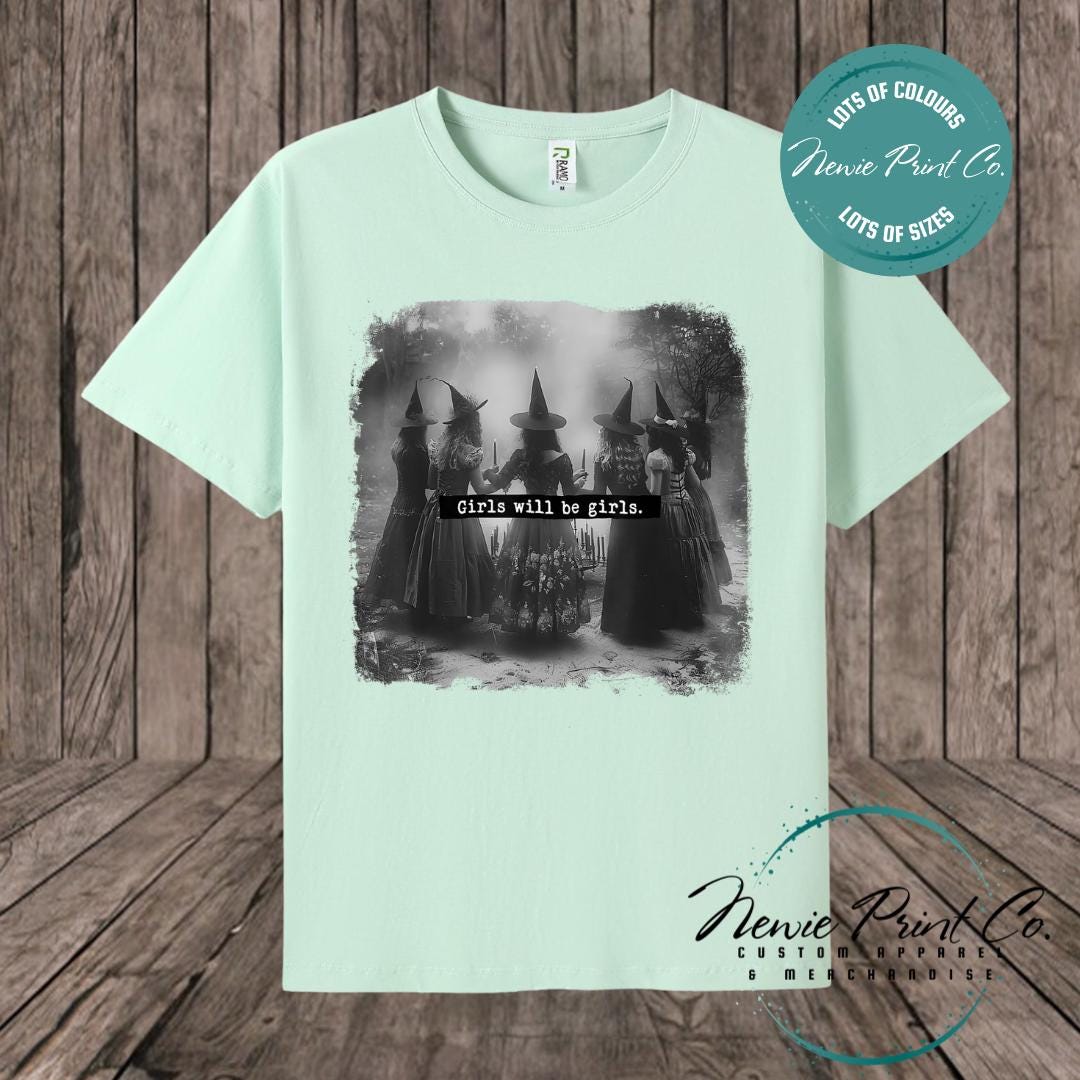 Witches in the forest design on custom t-shirt with the slogan “Girls Will Be Girls”. Feminist and empowering print on 100% cotton tee, perfect for girls and women, printed using high-quality DTF/DTG technology.