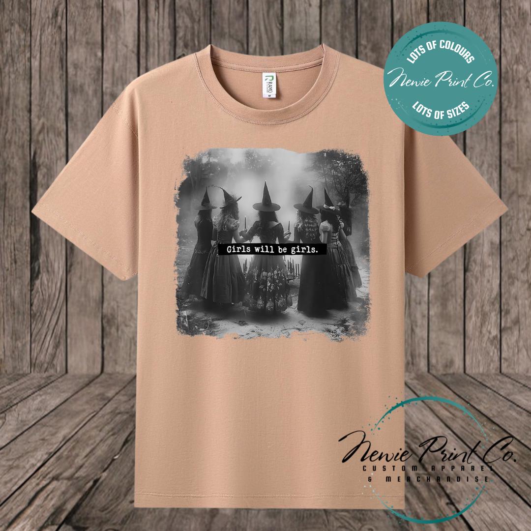 Witches in the forest design on custom t-shirt with the slogan “Girls Will Be Girls”. Feminist and empowering print on 100% cotton tee, perfect for girls and women, printed using high-quality DTF/DTG technology.