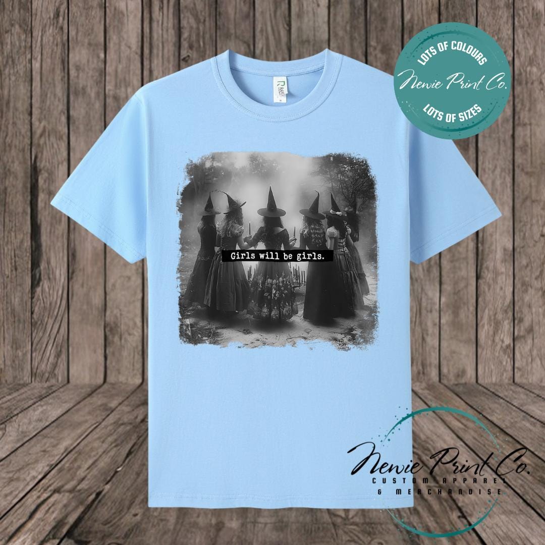 Witches in the forest design on custom t-shirt with the slogan “Girls Will Be Girls”. Feminist and empowering print on 100% cotton tee, perfect for girls and women, printed using high-quality DTF/DTG technology.