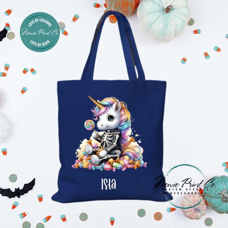 Custom Halloween tote bag with unicorn dressed as a skeleton surrounded by lollies and candy, optional personalised name printed on the front, perfect for trick-or-treating or spooky season gifts