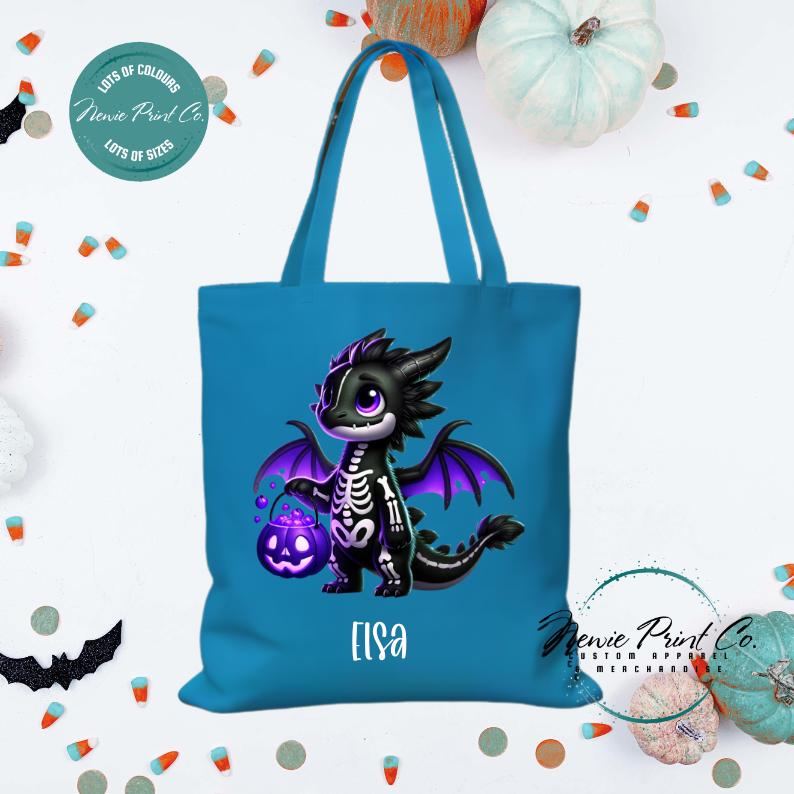 Custom Halloween tote bag with a cute black and purple dragon holding a pumpkin, optional personalised name printed on the front, perfect for trick-or-treating or spooky season gifts printed in Australia.