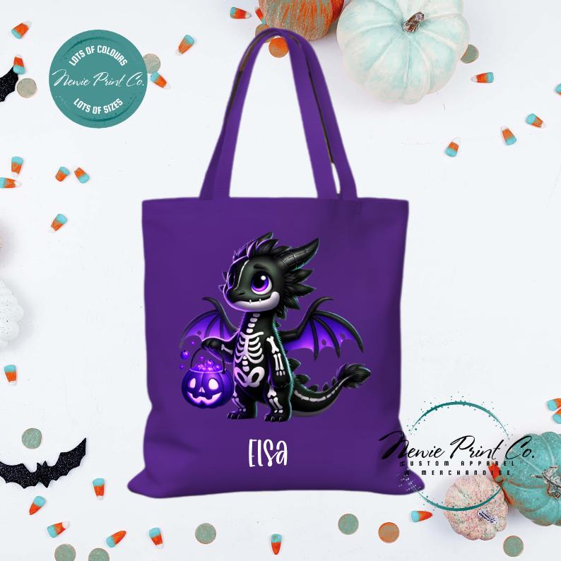 Custom Halloween tote bag with a cute black and purple dragon holding a pumpkin, optional personalised name printed on the front, perfect for trick-or-treating or spooky season gifts printed in Australia.