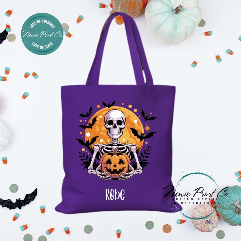 Custom Halloween tote bag with a skeleton holding a pumpkin and a big orange moon and bats behind him, optional personalised name printed on the front, perfect for trick-or-treating or spooky season gifts printed in Australia.
