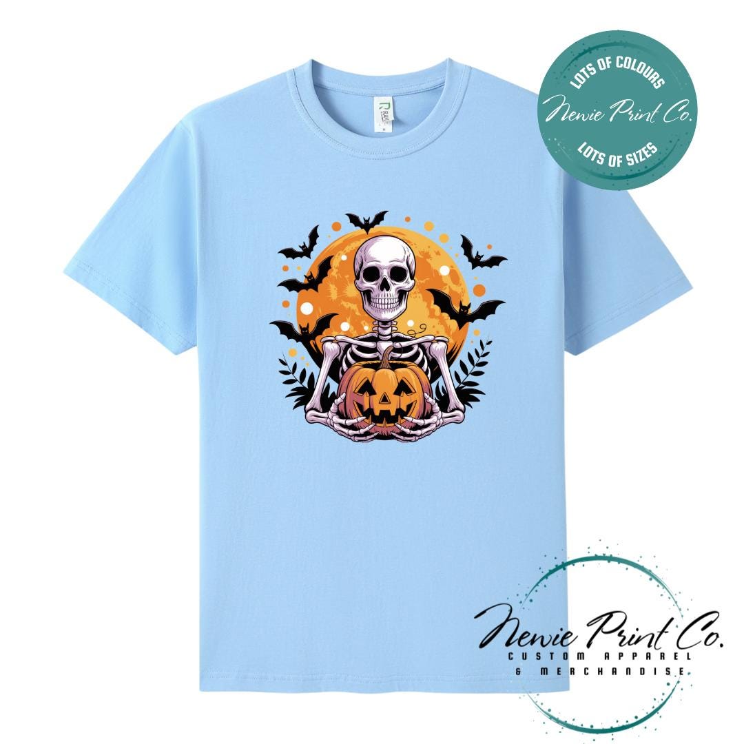 Custom Halloween t-shirts printed by Newie Print Co, featuring spooky skeleton design and optional personalised names — perfect for Halloween parties, school events, or family matching outfits.