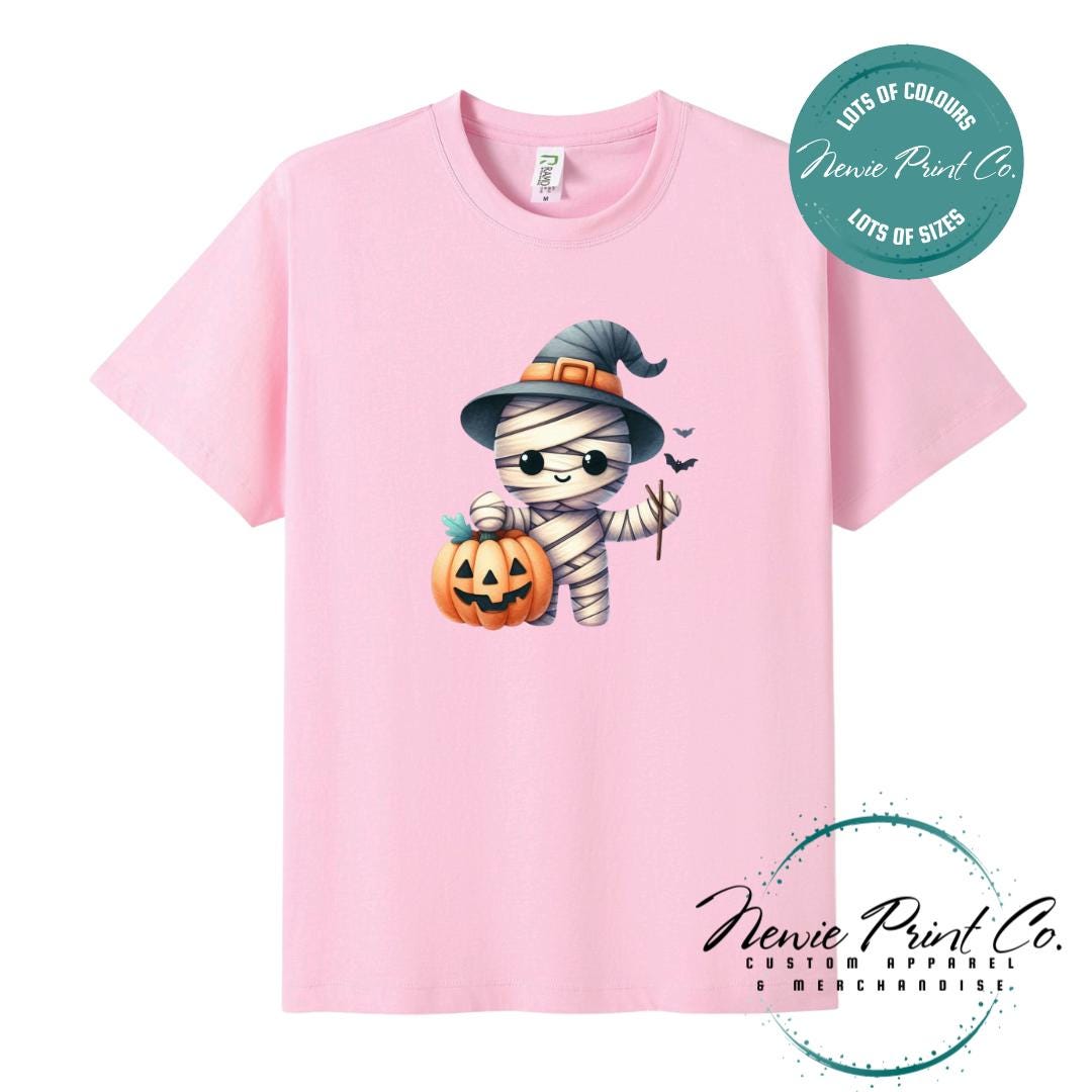 Custom Halloween t-shirts printed in Australia, featuring a cute but spooky mummy witch design and optional personalised names — perfect for Halloween parties, school events, or family matching outfits.