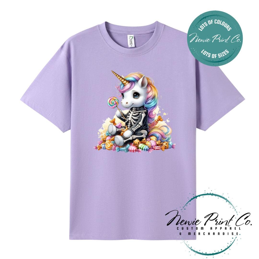 Custom Halloween t-shirts printed in Australia, featuring a cute but spooky unicorn dressed a skeleton sitting on a pile of candy design and optional personalised names — perfect for Halloween parties, school events, or family matching outfits.