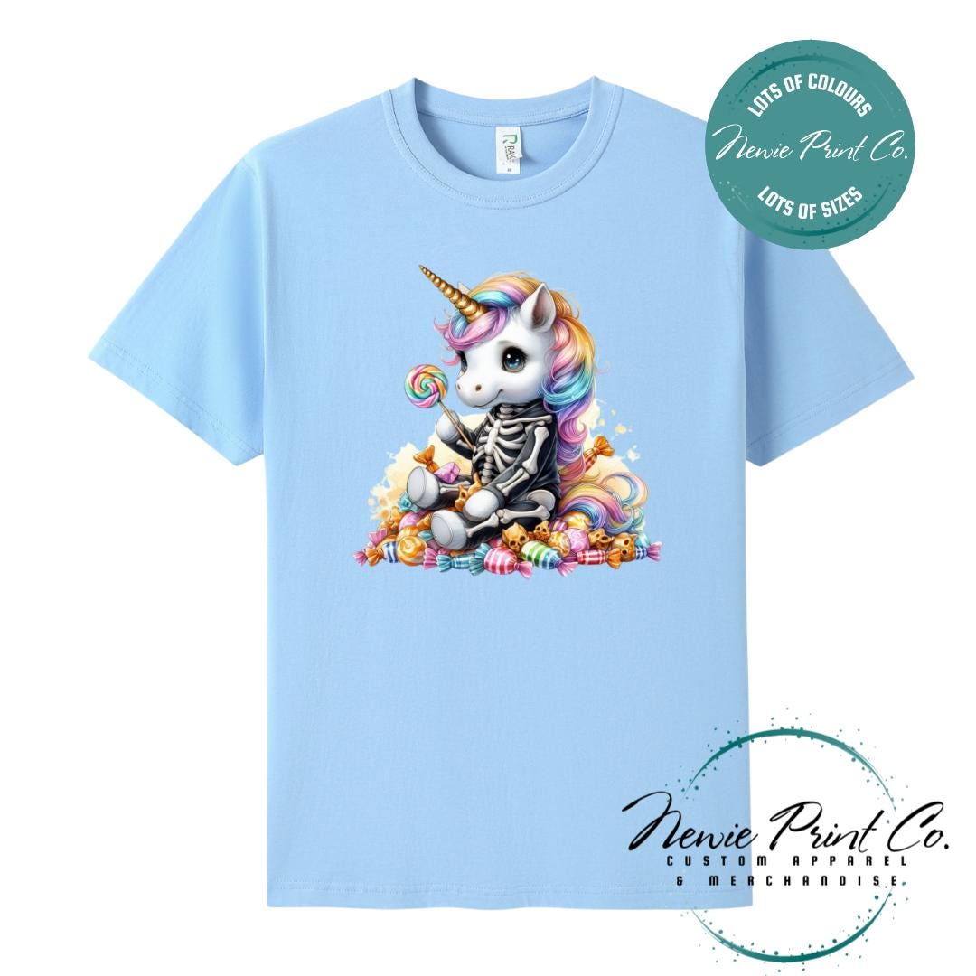 Custom Halloween t-shirts printed in Australia, featuring a cute but spooky unicorn dressed a skeleton sitting on a pile of candy design and optional personalised names — perfect for Halloween parties, school events, or family matching outfits.