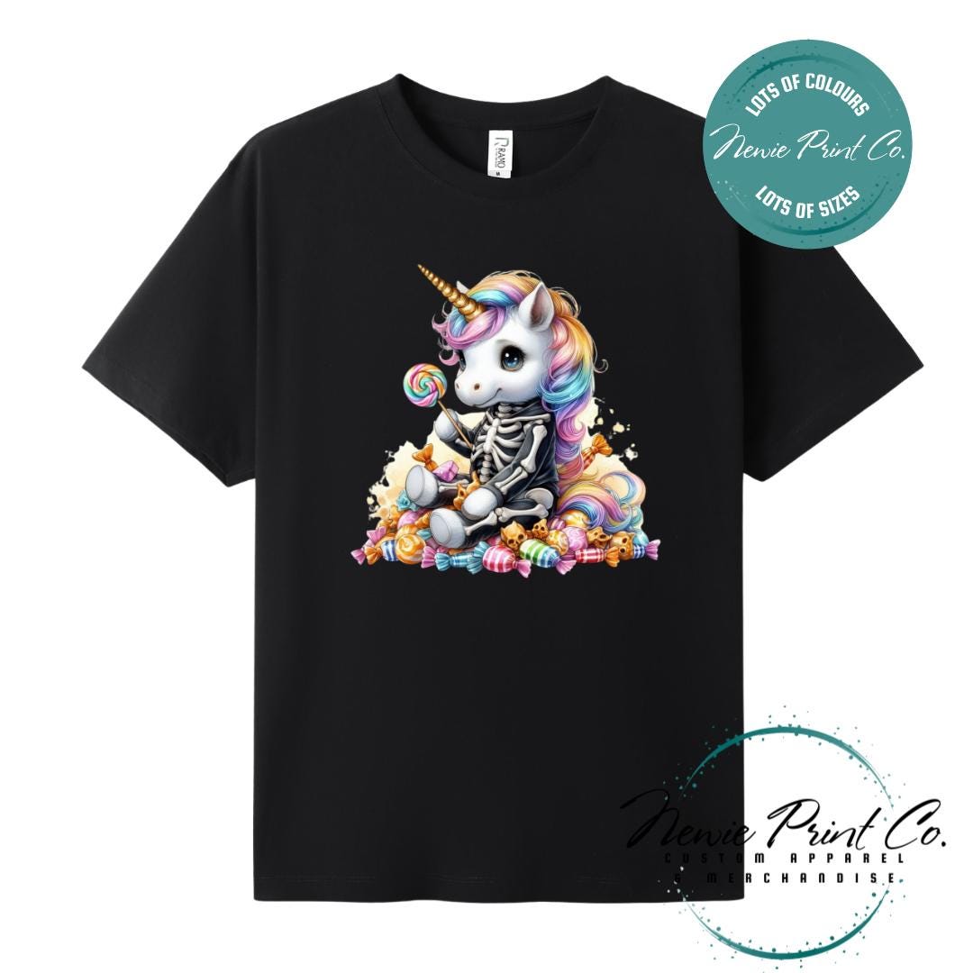 Custom Halloween t-shirts printed in Australia, featuring a cute but spooky unicorn dressed a skeleton sitting on a pile of candy design and optional personalised names — perfect for Halloween parties, school events, or family matching outfits.