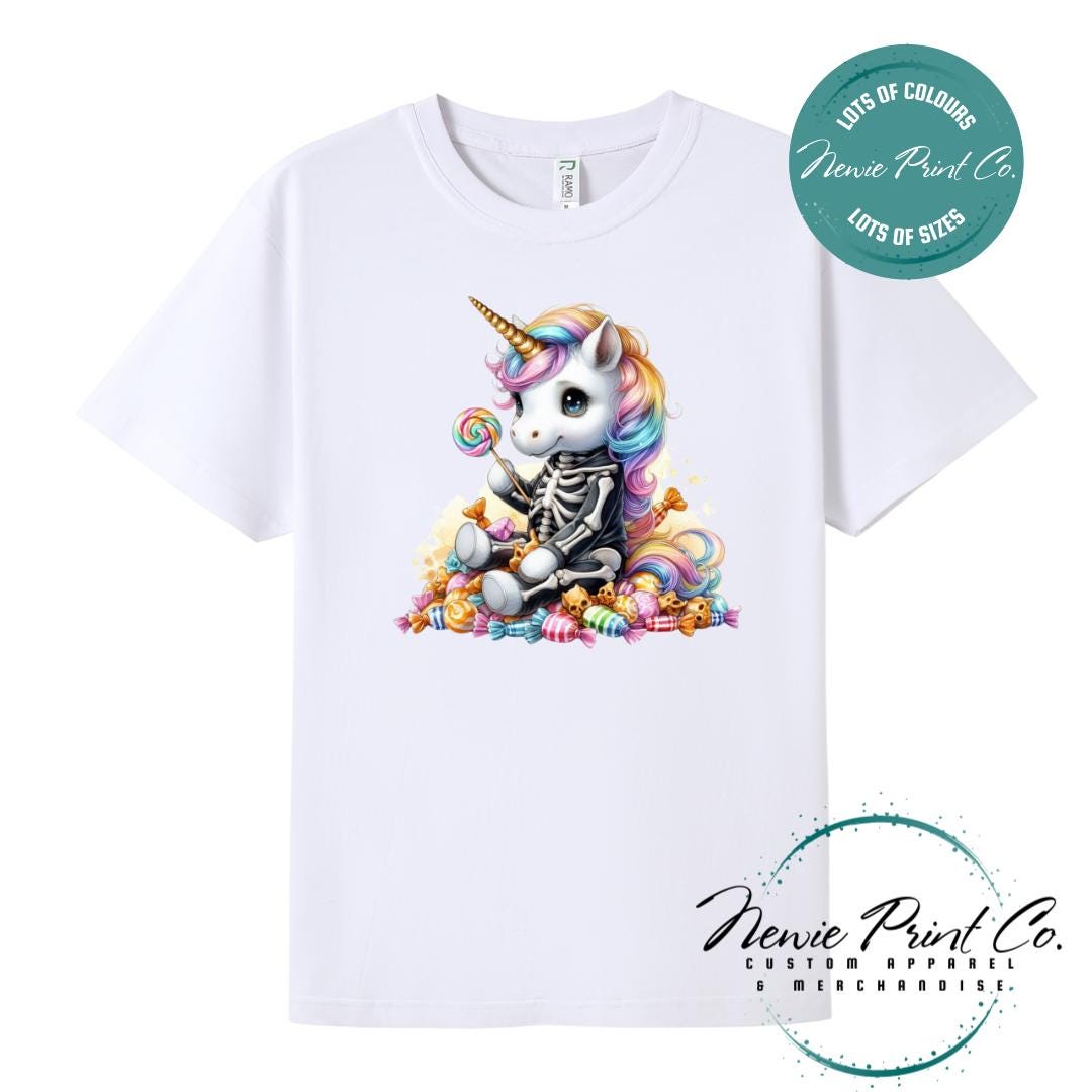 Custom Halloween t-shirts printed in Australia, featuring a cute but spooky unicorn dressed a skeleton sitting on a pile of candy design and optional personalised names — perfect for Halloween parties, school events, or family matching outfits.