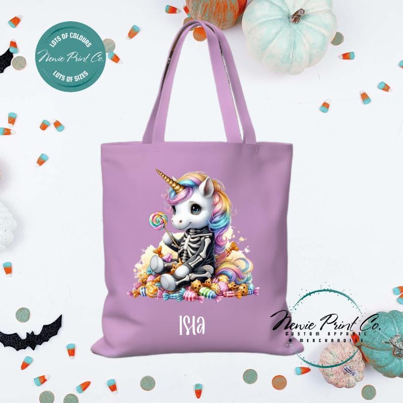 Custom Halloween tote bag with unicorn dressed as a skeleton surrounded by lollies and candy, optional personalised name printed on the front, perfect for trick-or-treating or spooky season gifts