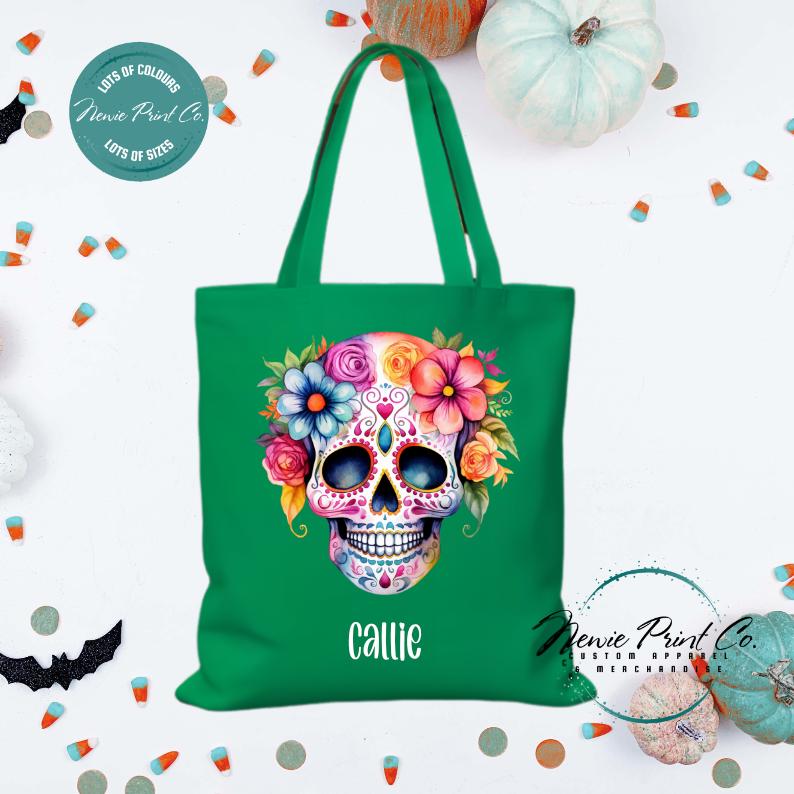 Custom Halloween tote bag with a bright floral sugar skull, optional personalised name printed on the front, perfect for trick-or-treating or spooky season gifts printed in Australia.