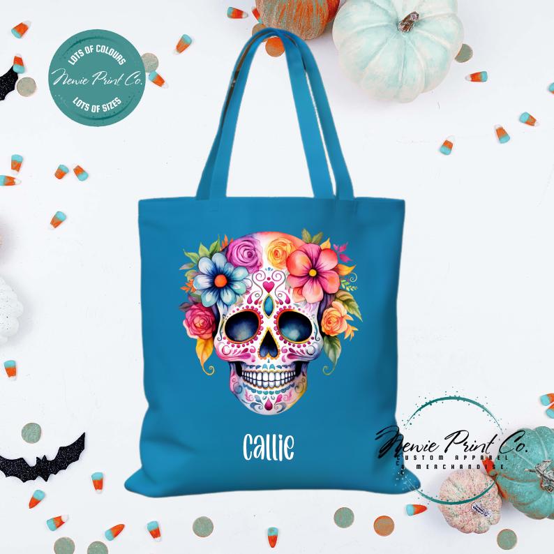 Custom Halloween tote bag with a bright floral sugar skull, optional personalised name printed on the front, perfect for trick-or-treating or spooky season gifts printed in Australia.