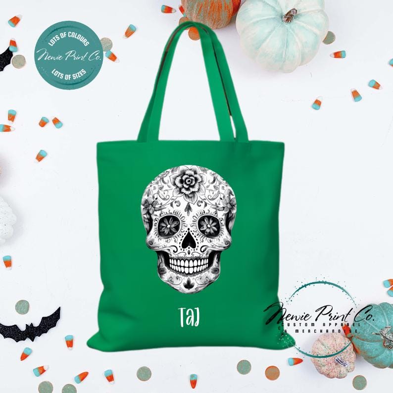 Custom Halloween tote bag with a black and white sugar skull, optional personalised name printed on the front, perfect for trick-or-treating or spooky season gifts printed in Australia.