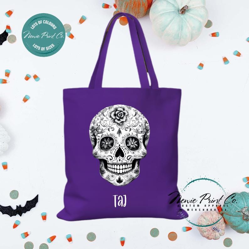 Custom Halloween tote bag with a black and white sugar skull, optional personalised name printed on the front, perfect for trick-or-treating or spooky season gifts printed in Australia.
