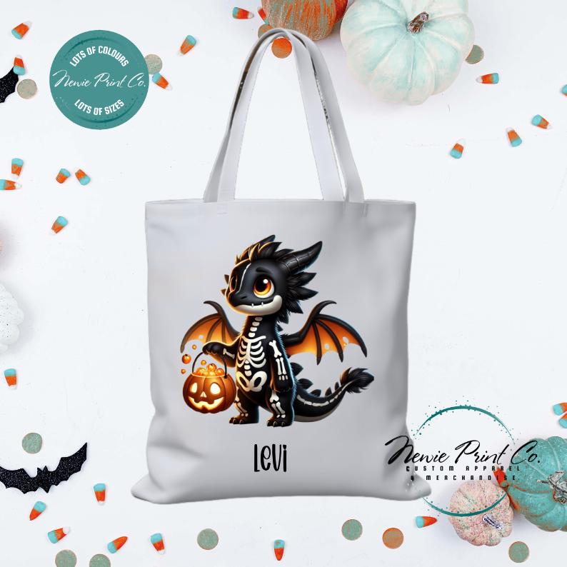 Custom Halloween tote bag with a cute black and orange dragon holding a pumpkin, optional personalised name printed on the front, perfect for trick-or-treating or spooky season gifts Printed in Australia.