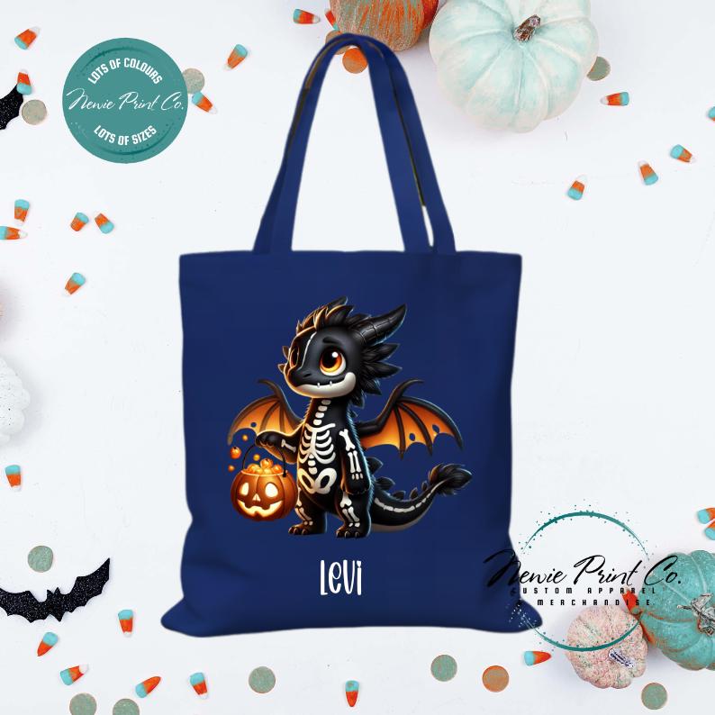 Custom Halloween tote bag with a cute black and orange dragon holding a pumpkin, optional personalised name printed on the front, perfect for trick-or-treating or spooky season gifts Printed in Australia.
