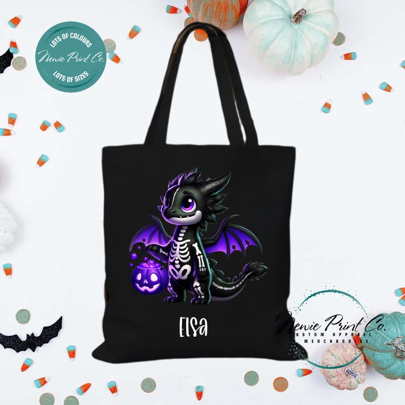 Custom Halloween tote bag with a cute black and purple dragon holding a pumpkin, optional personalised name printed on the front, perfect for trick-or-treating or spooky season gifts printed in Australia.