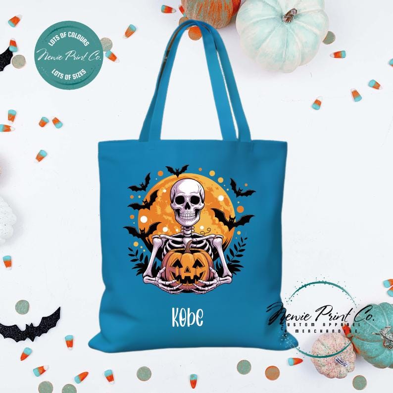 Custom Halloween tote bag with a skeleton holding a pumpkin and a big orange moon and bats behind him, optional personalised name printed on the front, perfect for trick-or-treating or spooky season gifts printed in Australia.