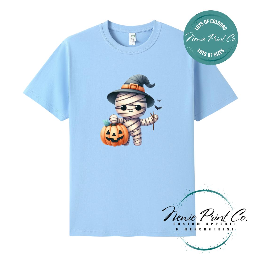 Custom Halloween t-shirts printed in Australia, featuring a cute but spooky mummy witch design and optional personalised names — perfect for Halloween parties, school events, or family matching outfits.