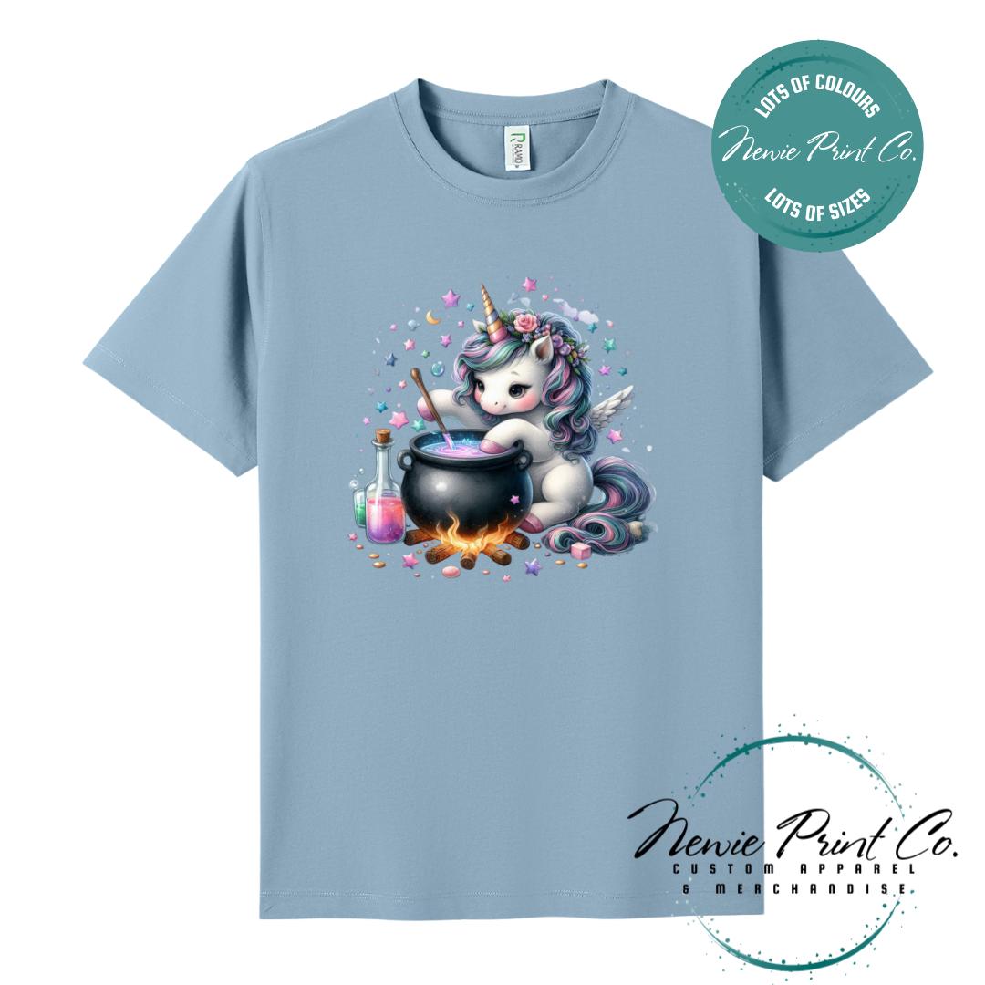 Custom Halloween t-shirts printed in Australia, featuring a cute and spooky unicorn and cauldron design and optional personalised names — perfect for Halloween parties, school events, or family matching outfits.