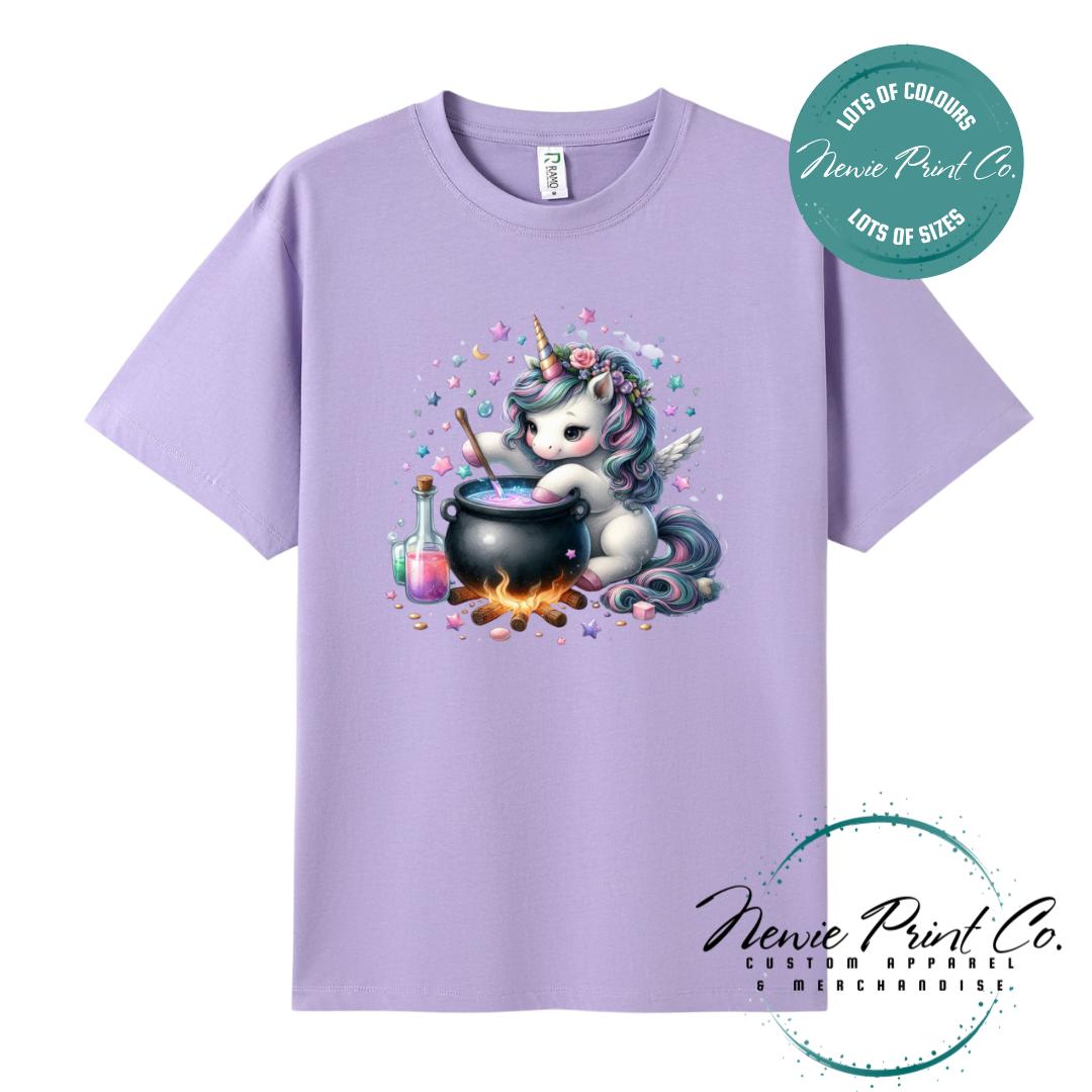 Custom Halloween t-shirts printed in Australia, featuring a cute and spooky unicorn and cauldron design and optional personalised names — perfect for Halloween parties, school events, or family matching outfits.