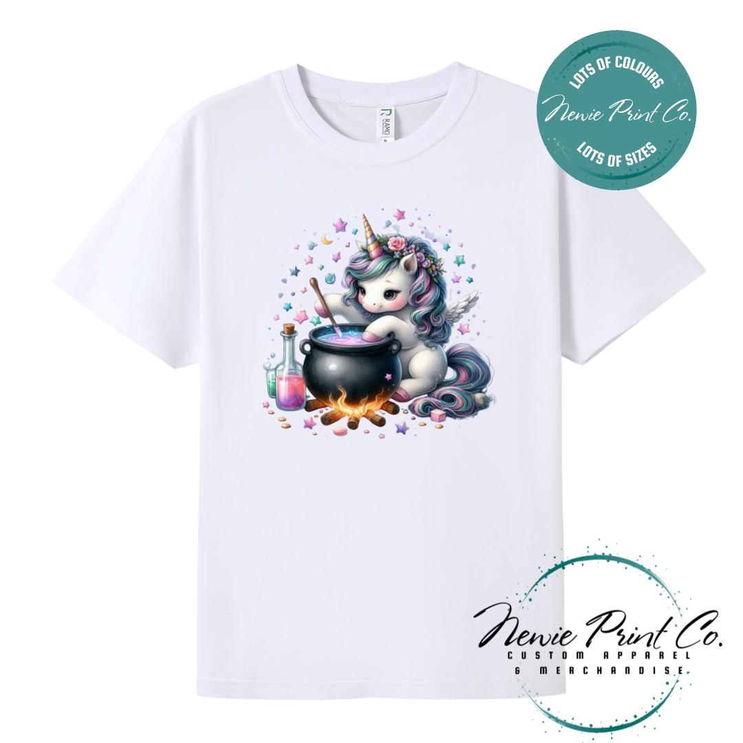 Custom Halloween t-shirts printed in Australia, featuring a cute and spooky unicorn and cauldron design and optional personalised names — perfect for Halloween parties, school events, or family matching outfits.