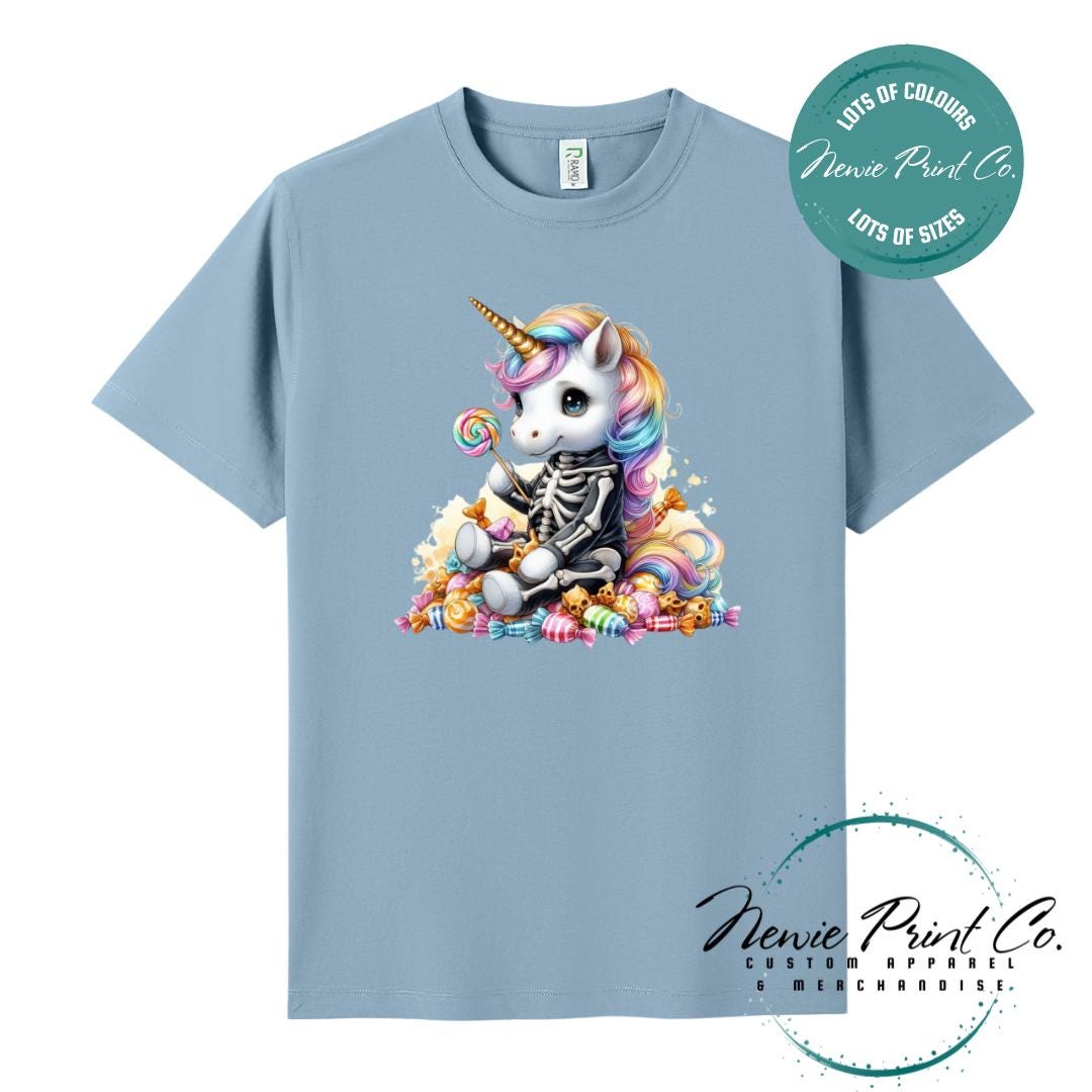 Custom Halloween t-shirts printed in Australia, featuring a cute but spooky unicorn dressed a skeleton sitting on a pile of candy design and optional personalised names — perfect for Halloween parties, school events, or family matching outfits.