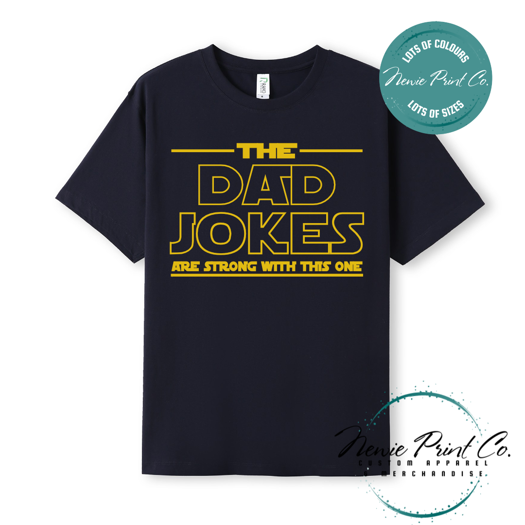 Funny t-shirt and jumper with the text “The Dad Jokes Are Strong With This One”. Humorous Star Wars-inspired quote printed on 100% cotton apparel using high-quality DTF/DTG print. Perfect gift for dads, Father’s Day, or star wars lovers.