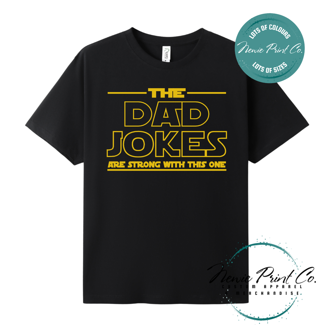 Funny t-shirt and jumper with the text “The Dad Jokes Are Strong With This One”. Humorous Star Wars-inspired quote printed on 100% cotton apparel using high-quality DTF/DTG print. Perfect gift for dads, Father’s Day, or star wars lovers.