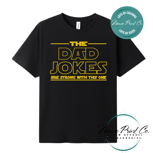 Funny t-shirt and jumper with the text “The Dad Jokes Are Strong With This One”. Humorous Star Wars-inspired quote printed on 100% cotton apparel using high-quality DTF/DTG print. Perfect gift for dads, Father’s Day, or star wars lovers.
