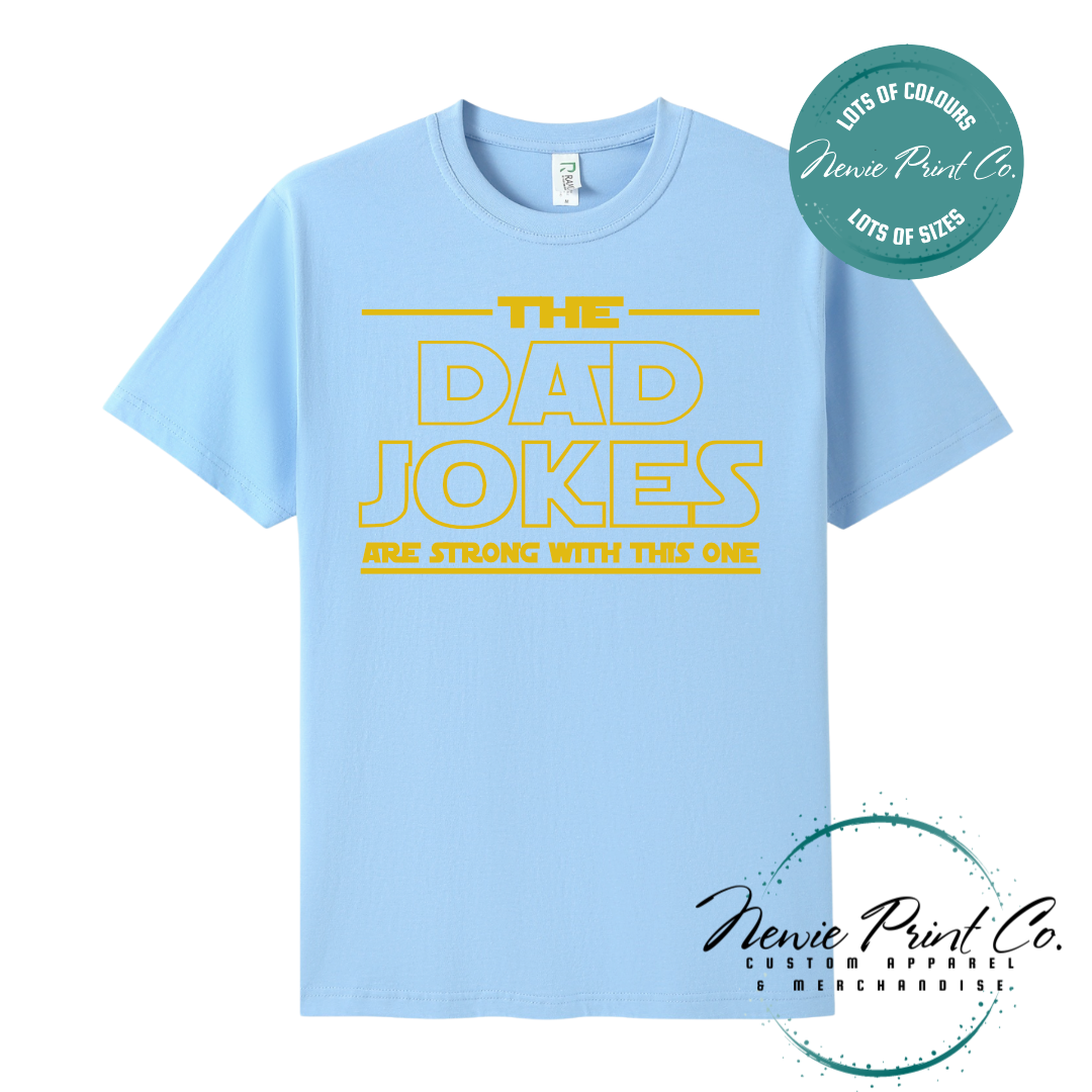 Funny t-shirt and jumper with the text “The Dad Jokes Are Strong With This One”. Humorous Star Wars-inspired quote printed on 100% cotton apparel using high-quality DTF/DTG print. Perfect gift for dads, Father’s Day, or star wars lovers.