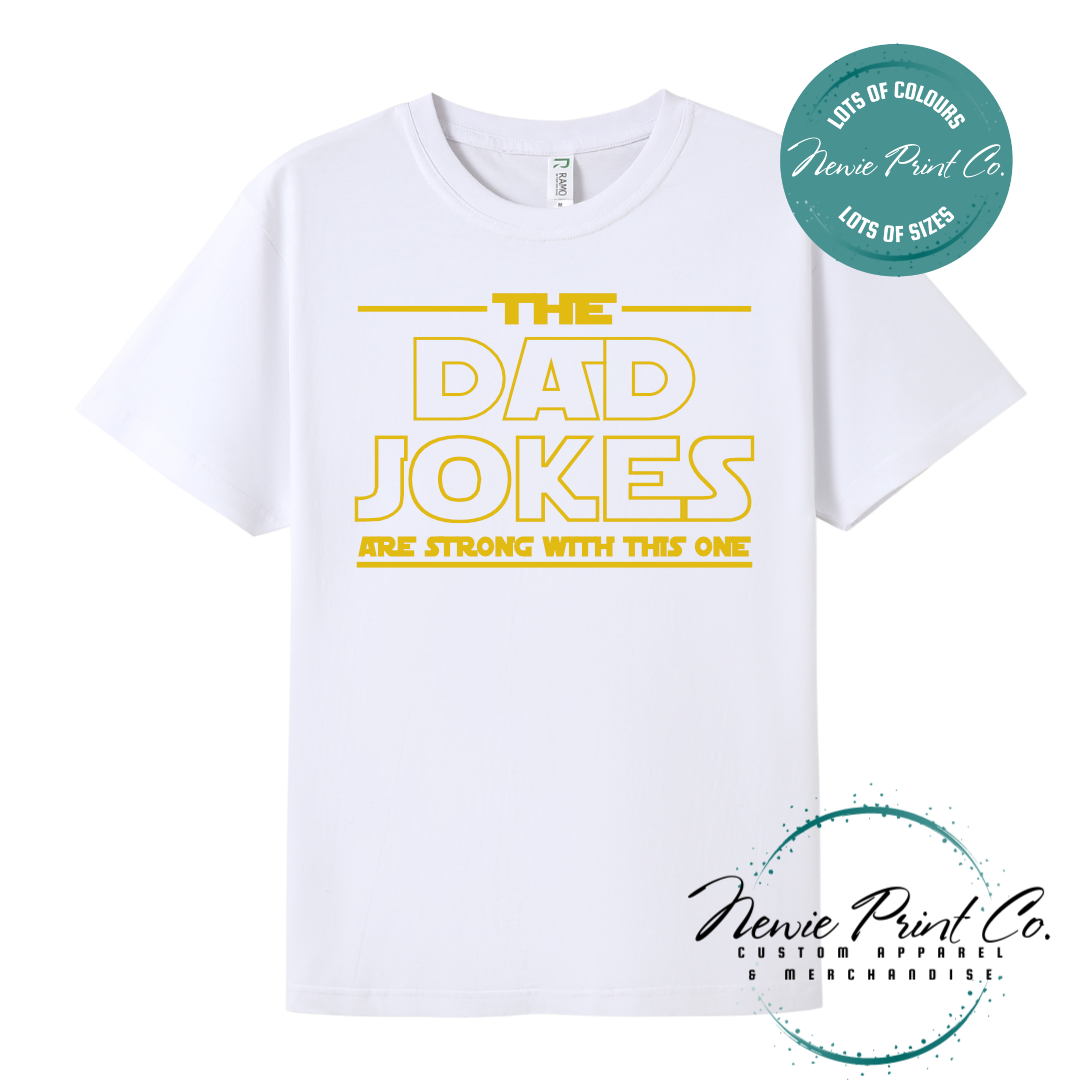Funny t-shirt and jumper with the text “The Dad Jokes Are Strong With This One”. Humorous Star Wars-inspired quote printed on 100% cotton apparel using high-quality DTF/DTG print. Perfect gift for dads, Father’s Day, or star wars lovers.