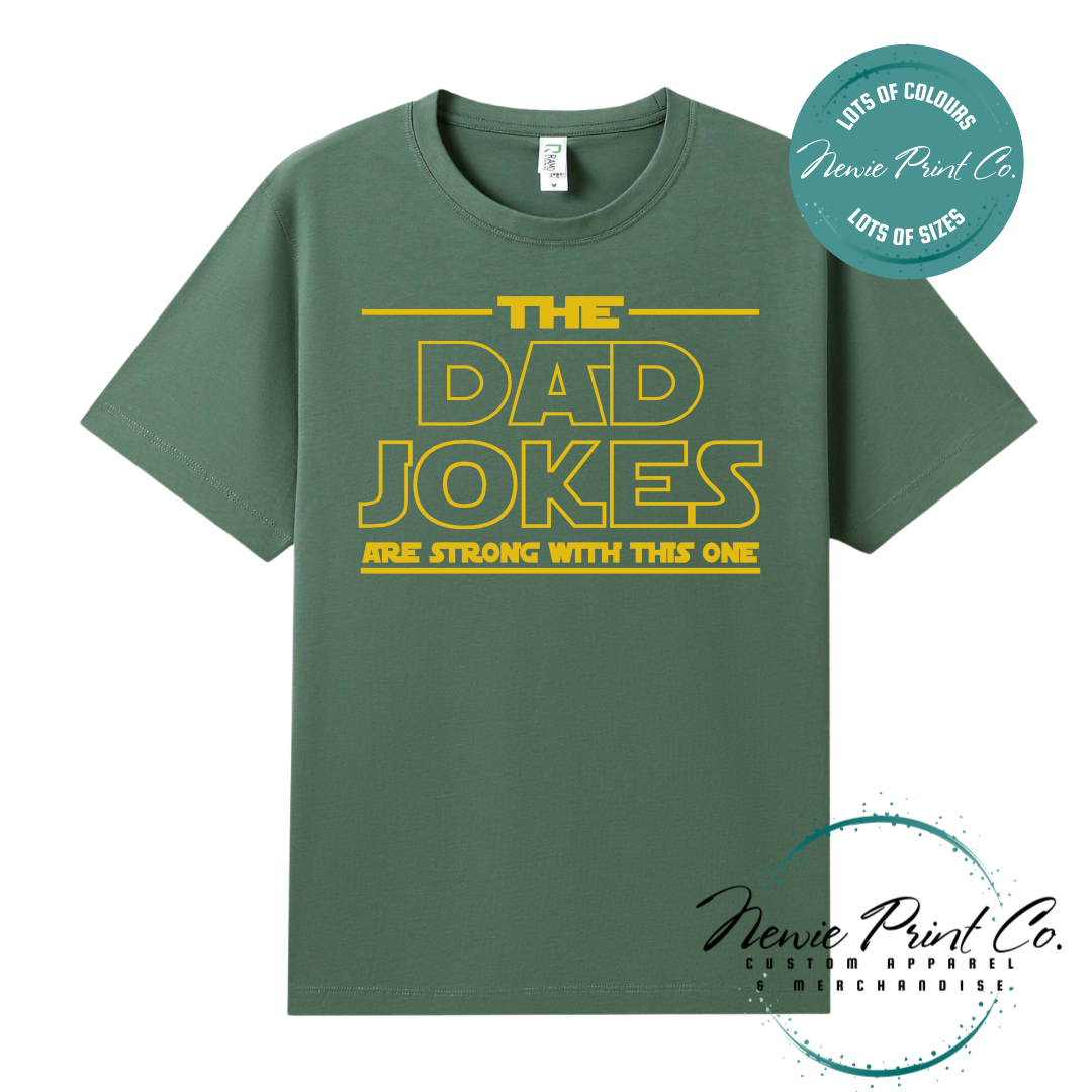 Funny t-shirt and jumper with the text “The Dad Jokes Are Strong With This One”. Humorous Star Wars-inspired quote printed on 100% cotton apparel using high-quality DTF/DTG print. Perfect gift for dads, Father’s Day, or star wars lovers.
