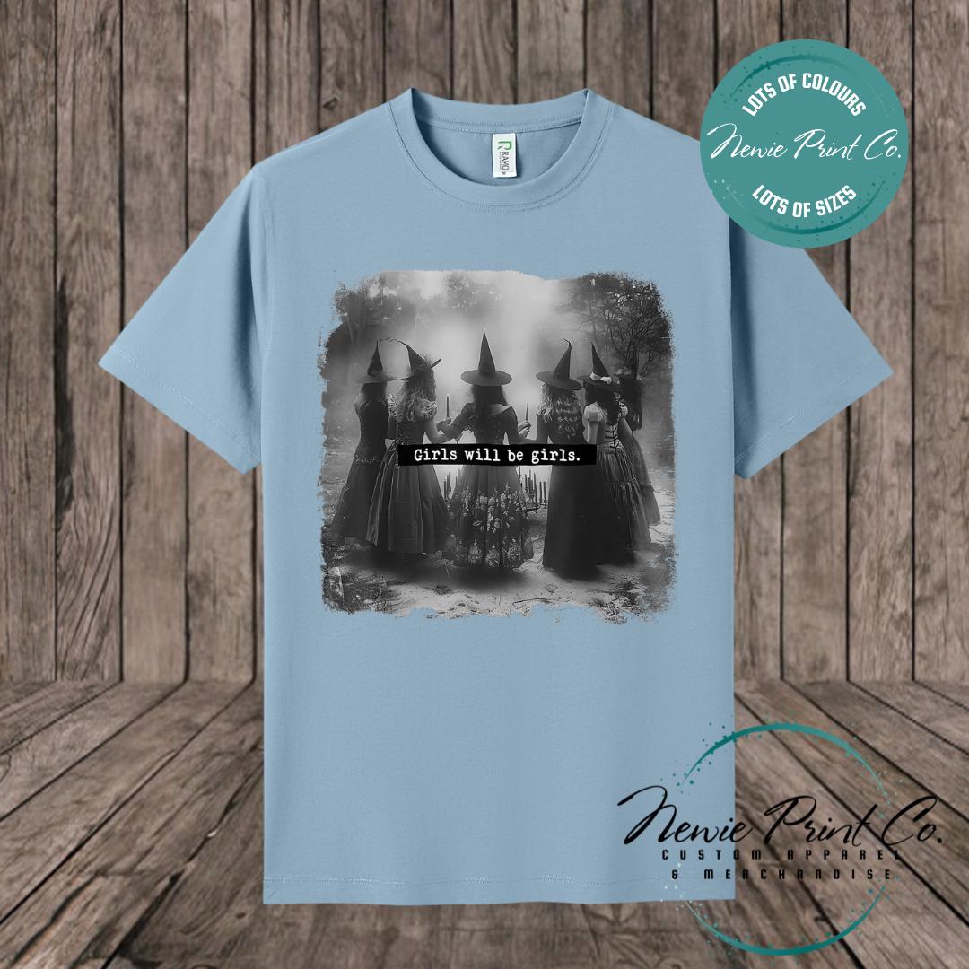 Witches in the forest design on custom t-shirt with the slogan “Girls Will Be Girls”. Feminist and empowering print on 100% cotton tee, perfect for girls and women, printed using high-quality DTF/DTG technology.