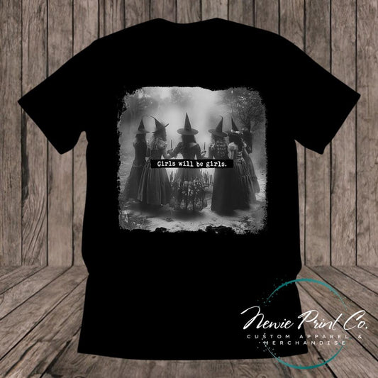 Witches in the forest design on custom t-shirt with the slogan “Girls Will Be Girls”. Feminist and empowering print on 100% cotton tee, perfect for girls and women, printed using high-quality DTF/DTG technology.