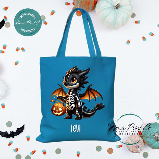 Custom Halloween tote bag with a cute black and orange dragon holding a pumpkin, optional personalised name printed on the front, perfect for trick-or-treating or spooky season gifts Printed in Australia by Newie Print Co.
