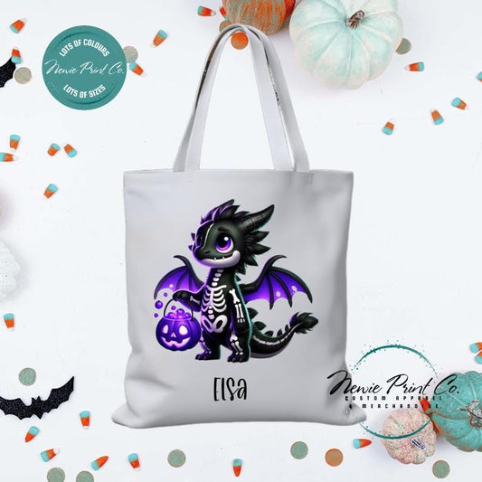 Custom Halloween tote bag with a cute black and purple dragon holding a pumpkin, optional personalised name printed on the front, perfect for trick-or-treating or spooky season gifts printed in Australia.