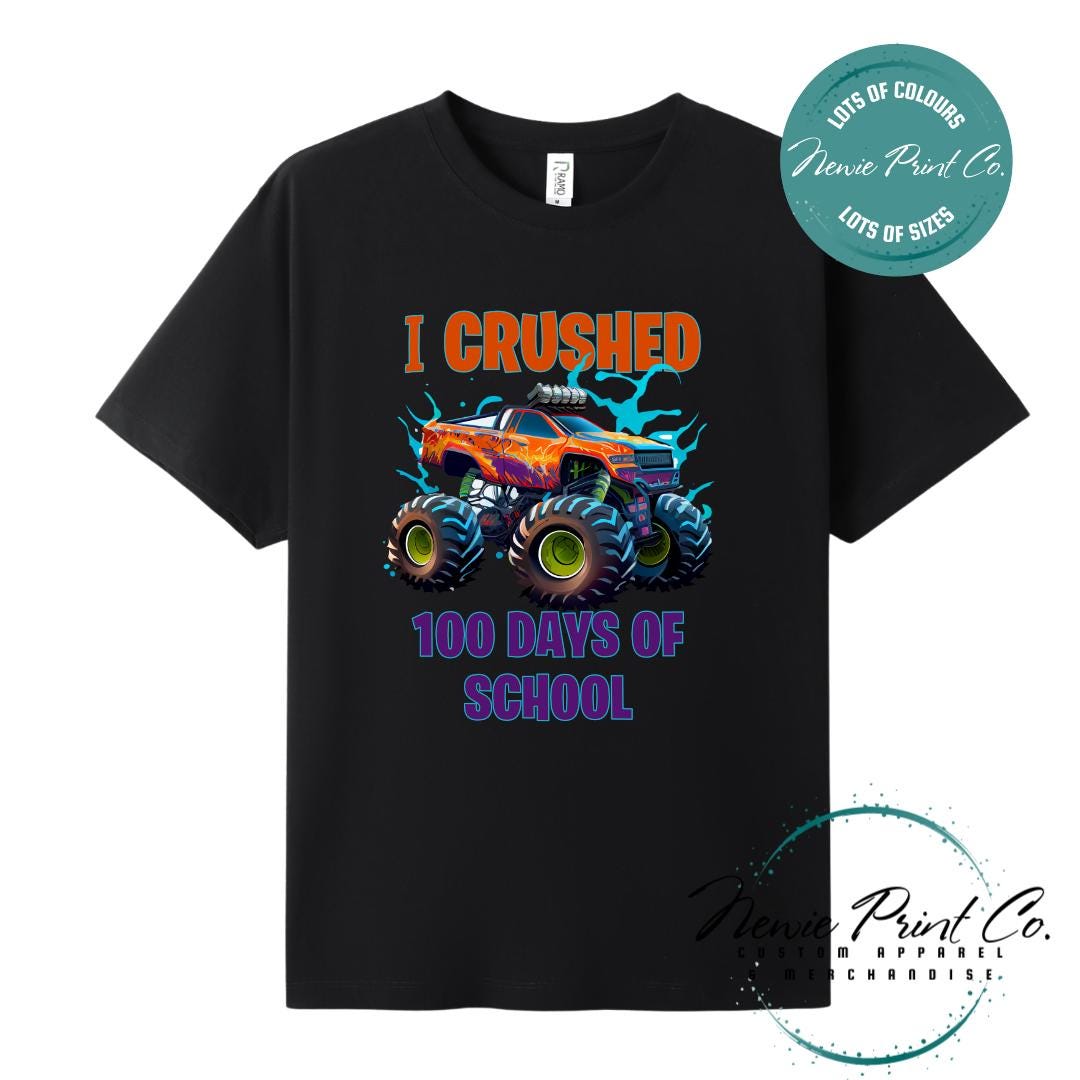 Black 100 Days of School t-shirt featuring a bold monster truck graphic with the text “I Crushed 100 Days of School,” designed for students or teachers to celebrate the 100th day of school milestone in a fun, playful way. Available in both adult and kids sizes.