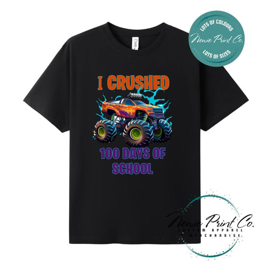 Black 100 Days of School t-shirt featuring a bold monster truck graphic with the text “I Crushed 100 Days of School,” designed for students or teachers to celebrate the 100th day of school milestone in a fun, playful way. Available in both adult and kids sizes.