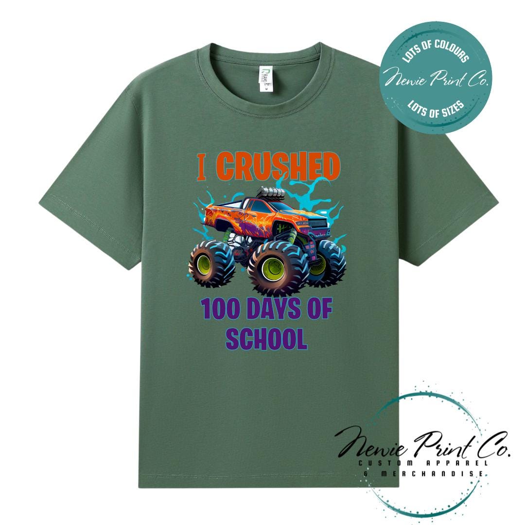 Army green 100 Days of School t-shirt featuring a bold monster truck graphic with the text “I Crushed 100 Days of School,” designed for students or teachers to celebrate the 100th day of school milestone in a fun, playful way. Available in both adult and kids sizes.