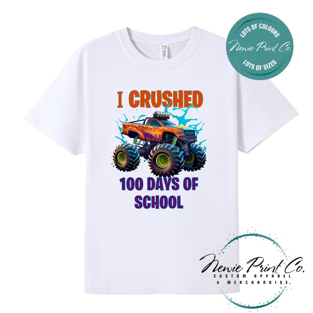 White 100 Days of School t-shirt featuring a bold monster truck graphic with the text “I Crushed 100 Days of School,” designed for students or teachers to celebrate the 100th day of school milestone in a fun, playful way. Available in both adult and kids sizes.
