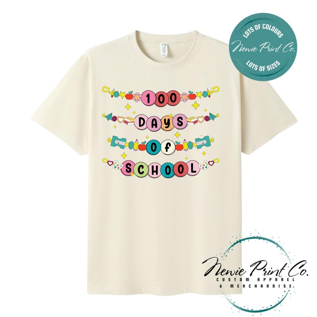 Natural 100 Days of School t-shirt featuring a colourful friendship bracelet with the text “100 Days of School,” designed for students or teachers to celebrate the 100th day of school milestone in a fun, playful way. Available in both adult and kids sizes.