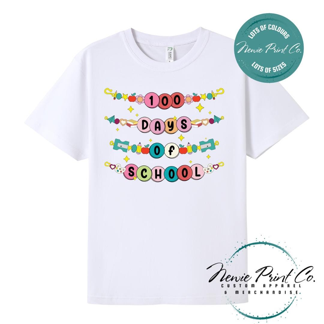 White 100 Days of School t-shirt featuring a colourful friendship bracelet with the text “100 Days of School,” designed for students or teachers to celebrate the 100th day of school milestone in a fun, playful way. Available in both adult and kids sizes.