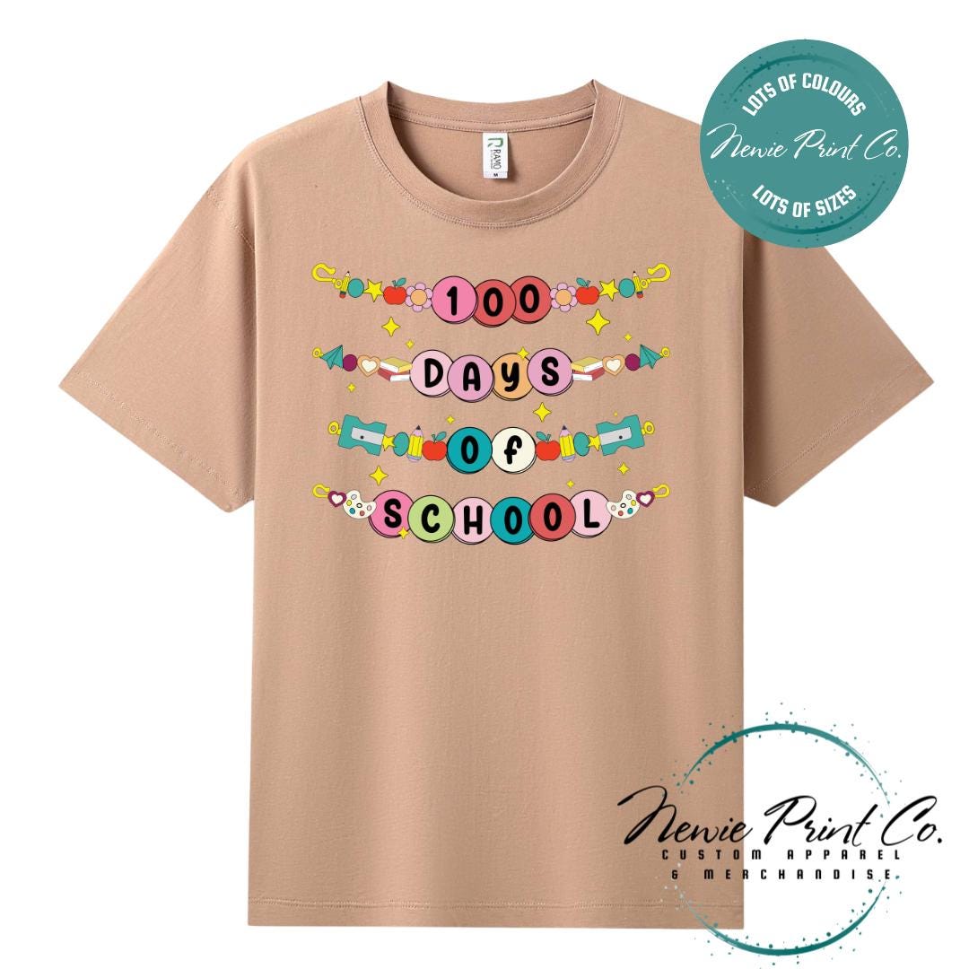 Peach 100 Days of School t-shirt featuring a colourful friendship bracelet with the text “100 Days of School,” designed for students or teachers to celebrate the 100th day of school milestone in a fun, playful way. Available in both adult and kids sizes.