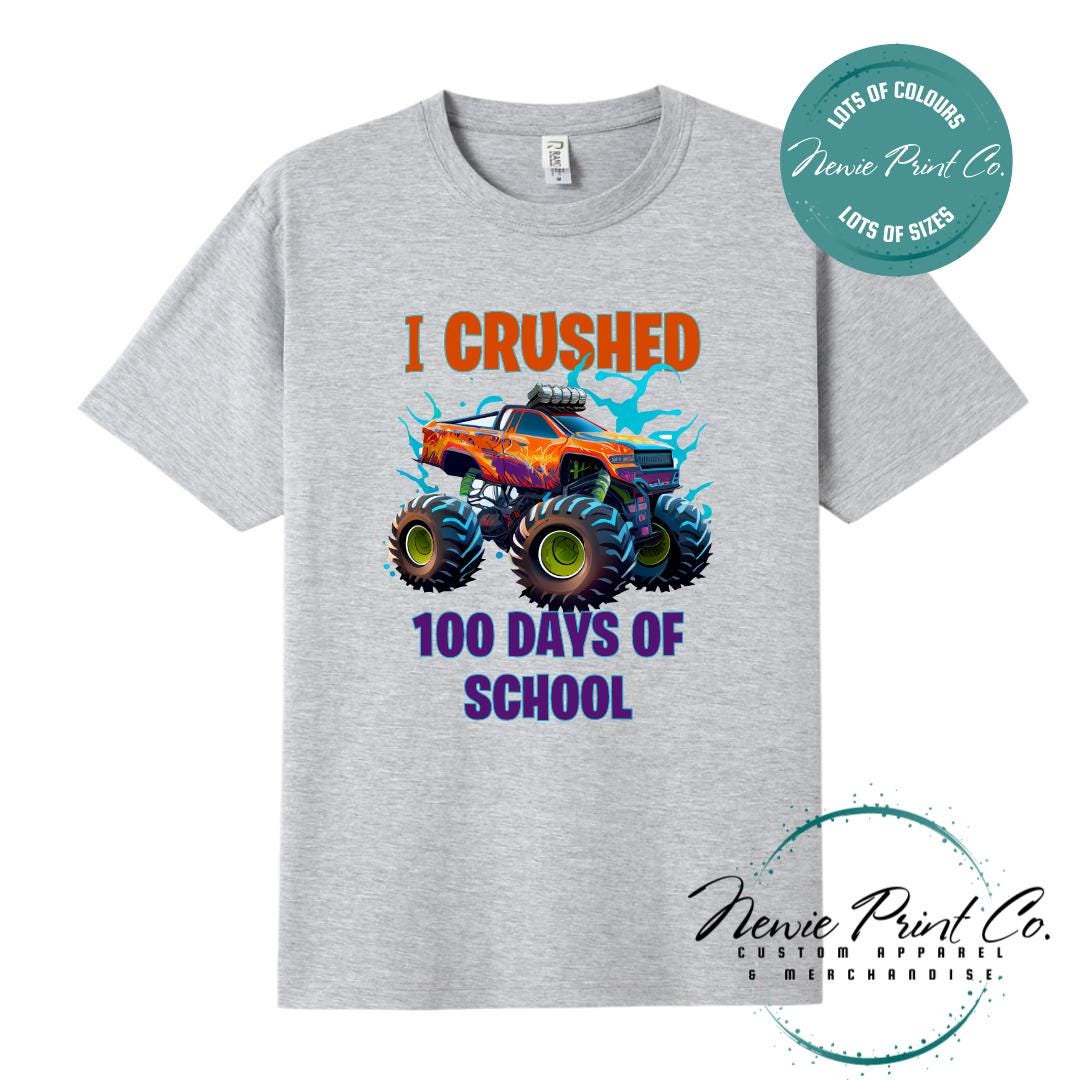 Grey Marl 100 Days of School t-shirt featuring a bold monster truck graphic with the text “I Crushed 100 Days of School,” designed for students or teachers to celebrate the 100th day of school milestone in a fun, playful way. Available in both adult and kids sizes.