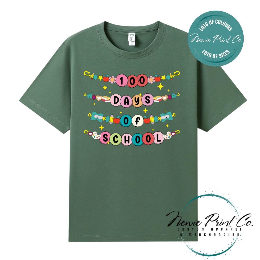 Army Green 100 Days of School t-shirt featuring a colourful friendship bracelet with the text “100 Days of School,” designed for students or teachers to celebrate the 100th day of school milestone in a fun, playful way. Available in both adult and kids sizes.
